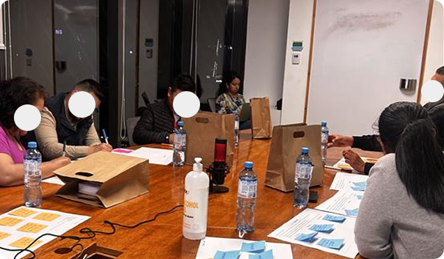 Workshop room with participants seated around a long table