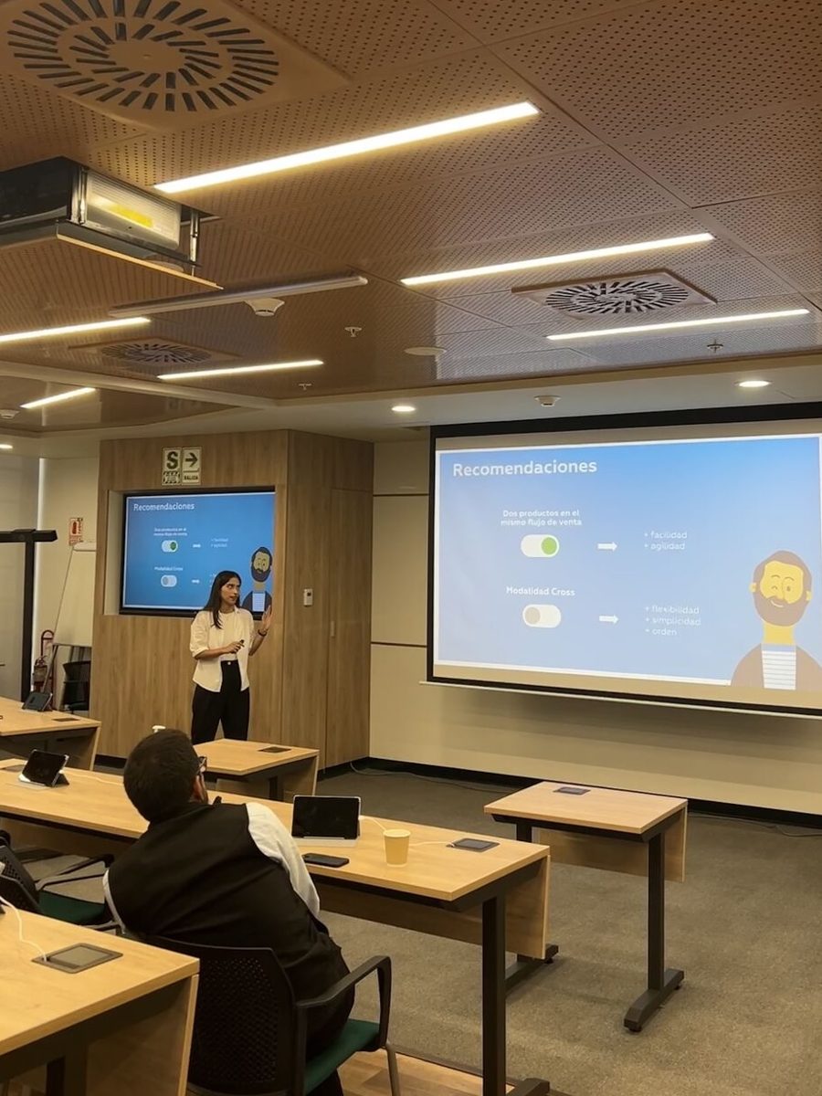 Tiffany presenting research recommendations on a projected slide in a meeting room